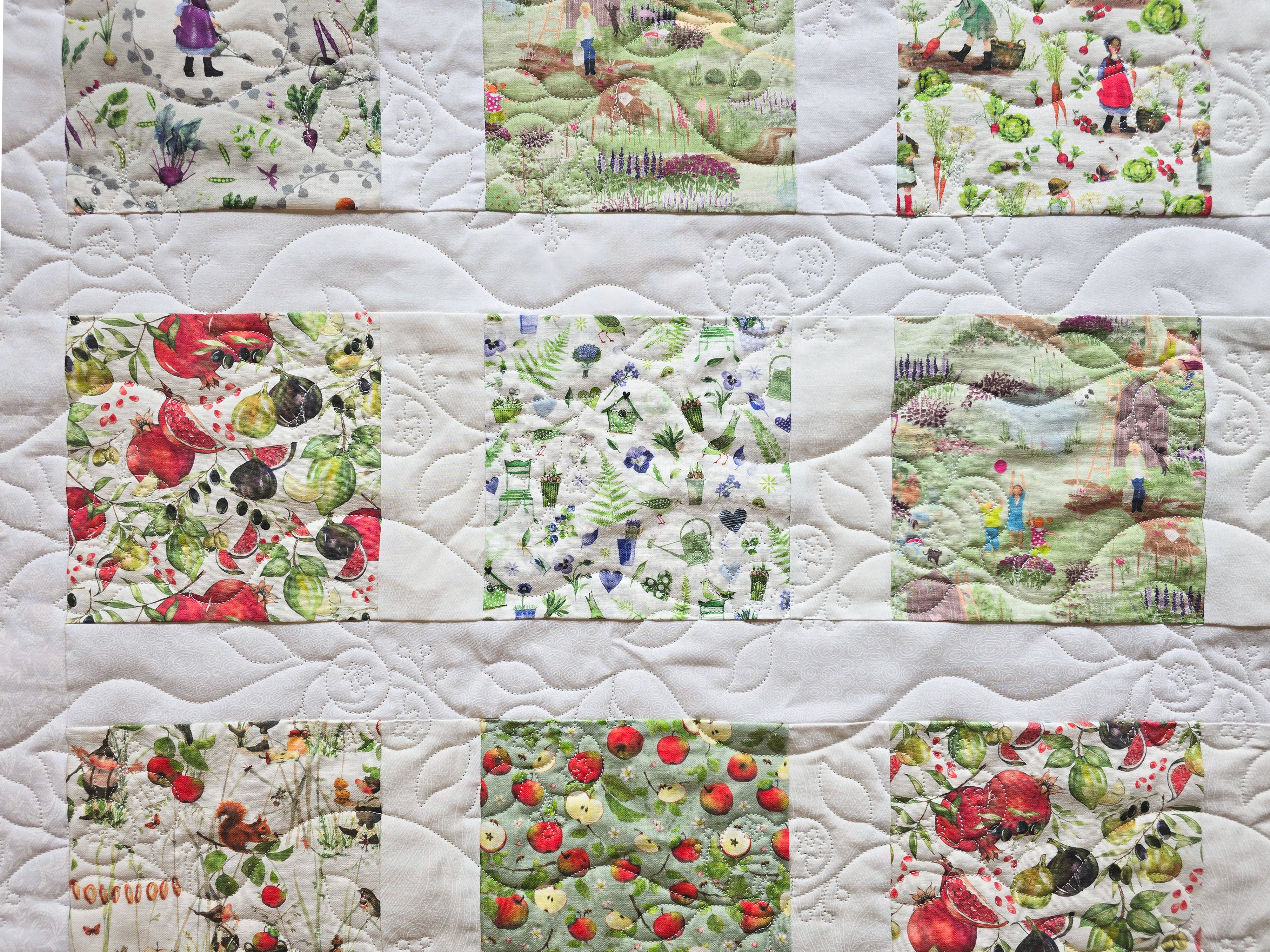 Close-up view of quilting stitches on a colorful quilt